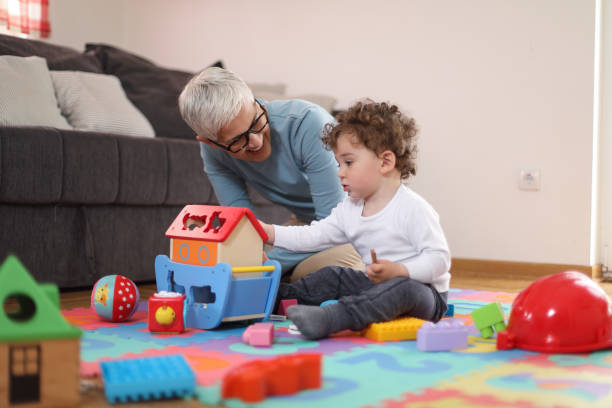 istock Grandmother playing with her grandson 1163343526