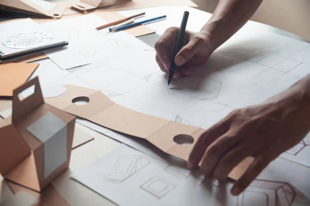 istock Designer sketching drawing design Brown craft cardboard paper product eco packaging mockup box development template package branding Label . designer studio concept . 1163346986