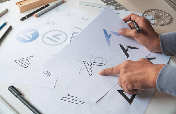 istock Graphic designer drawing sketch design creative Ideas draft Logo product trademark label brand artwork. Graphic designer studio Concept. 1163347022