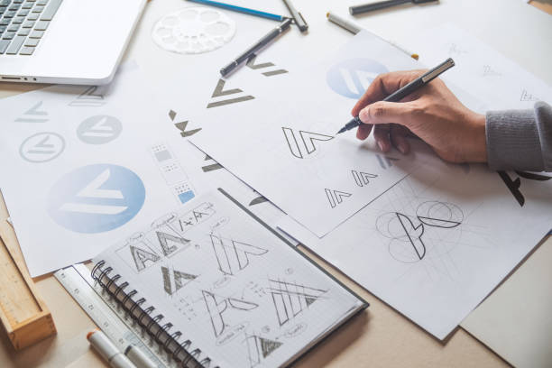 istock Graphic designer drawing sketch design creative Ideas draft Logo product trademark label brand artwork. Graphic designer studio Concept. 1163347024