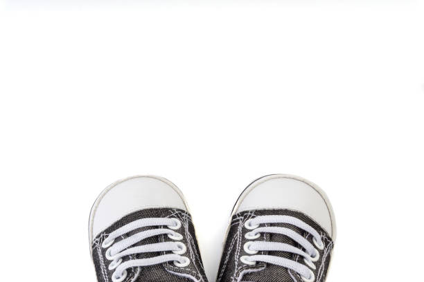 istock Baby shoes on white background. Selective focus 1163348199