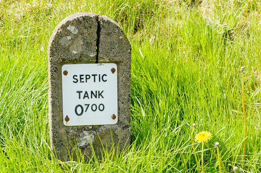 Concrete post marking the location of a septic tank