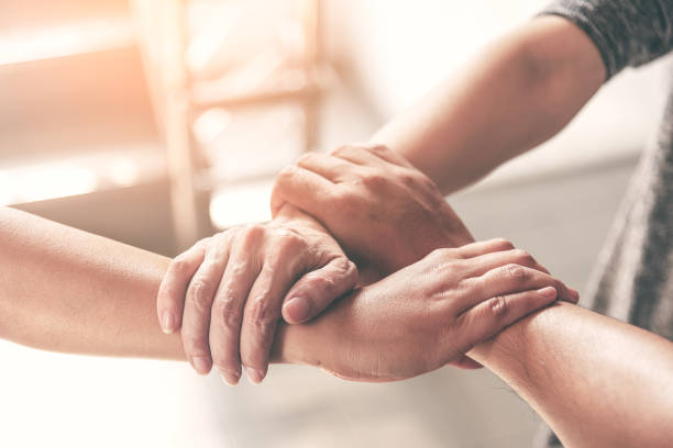 istock People hand assemble as a connection meeting teamwork concept. Group of people assembly hands as business or work achievement. Man and women touch each other hands after meeting. Teamwork conceptual. 1163348540