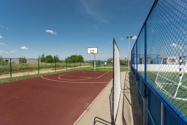istock Basketball structure in an outdoor playground surrounded by trees in a park 1163348609