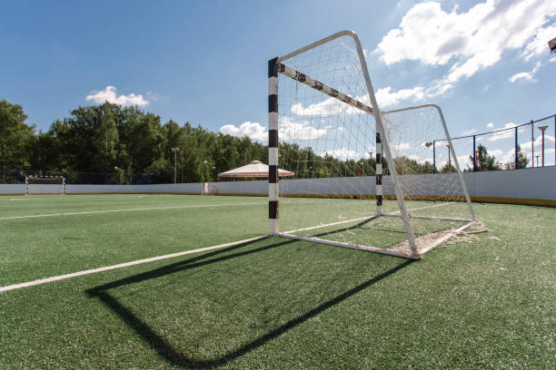 istock Football field. Artificial surface, green grass. Sport outdoors. Goal nets, white lines, circle center. 1163348695