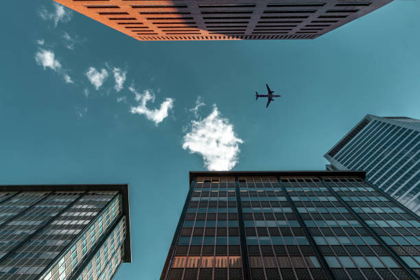istock airplane between tall skyscraper buildings in downtown cityscape 1163350030