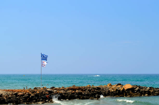 istock Gouves Old Harbour Greek flag flying 1163351447