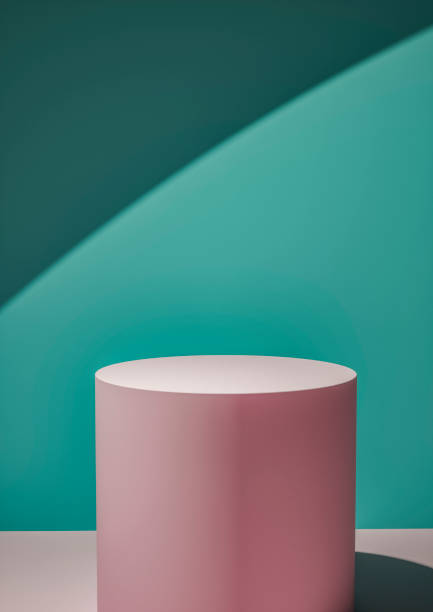 istock Pink circular display plinth against a green wall 1163351474