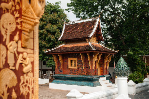 istock Wat Xieng thong temple small Buddha hall with mural art wall. 1163354286