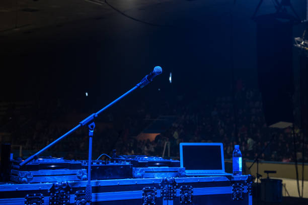 istock microphone in concert hall with blue lights 1163356987