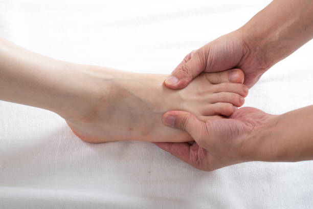 istock Close-up of female hands doing foot massage 1163358200