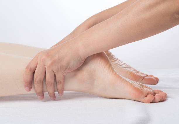 istock Close-up of female hands doing foot massage 1163358458
