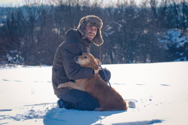 istock Man enjoying with golden retriever at winter 1163359836