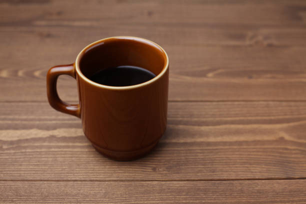 Close-up of a blue cup with black hot coffee