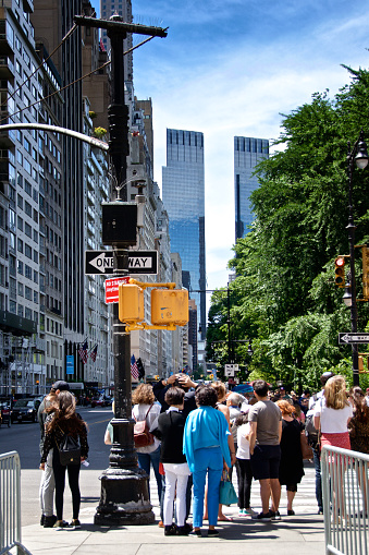 New York City, USA - June 08, 2019: A Crowd of pedestrians is seen waiting to cross roadway along W.59th Street, near Central Park, Upper Midtown of Manhattan, USA.