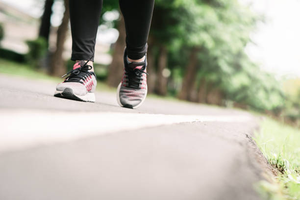 istock feet running on road in the park 1163361889