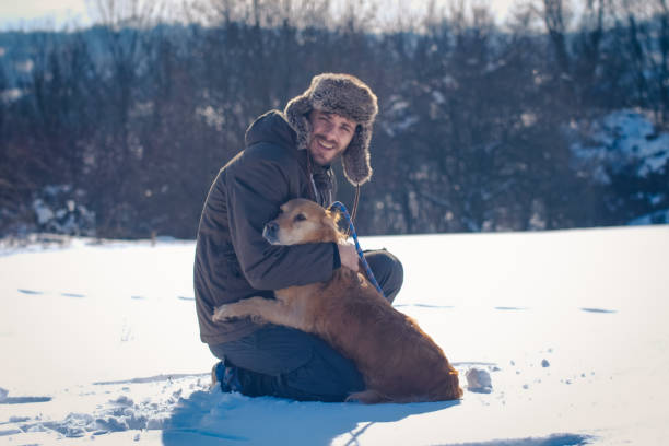 istock Man enjoying with golden retriever at winter 1163361975