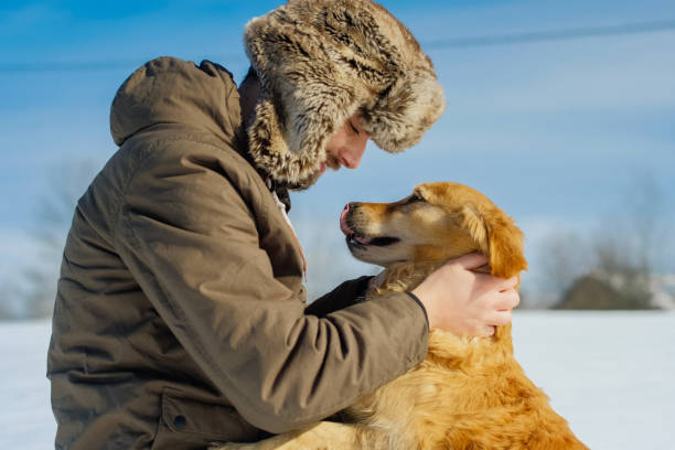 istock Man hiker and his dog on a mountain top 1163363901