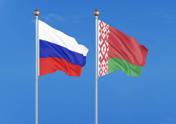 istock Russia vs Belarus. Thick colored silky flags of Russia and Belarus. 3D illustration on sky background. â Illustration 1163364007
