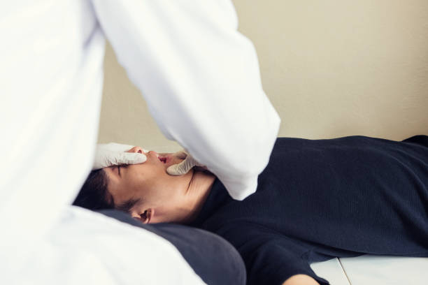 istock Doctor open addicted man mouth to check pills 1163364582
