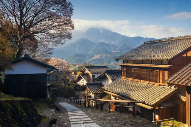 Magome juku preserved town in Nakasendo with central alps mountain at sunrise, Kiso valley in  Nakatsugawa, Gifu Prefecture, Japan. Famous travel landmark of old Japanese town.