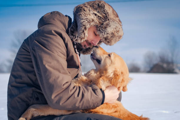 istock Man hiker and his dog on a mountain top 1163364833