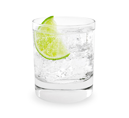 Gin tonic with lime slice isolated on white