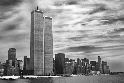 Twin Towers NYC in foreground. Archival and historical cityscape of New York skyline from Hudson River with World Trade Center. Lower Manhattan in NYC, United States. Vintage shot in black and white.