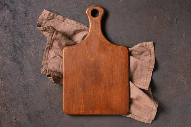 istock Brown textured background with empty wooden cutting board 1163365168