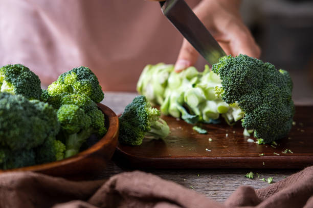 istock Fresh broccoli with wooden cutting board on old wooden table 1163365199