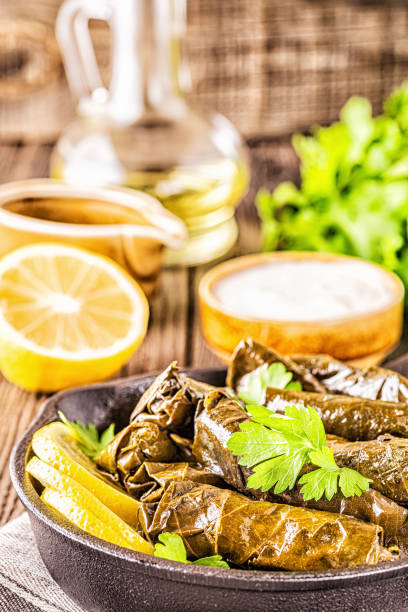 istock Dolma, stuffed grape leaves with rice and meat on dark background, selective focus 1163366238