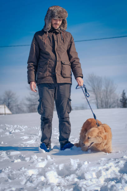 istock Man hiker and his dog on a mountain top 1163366336