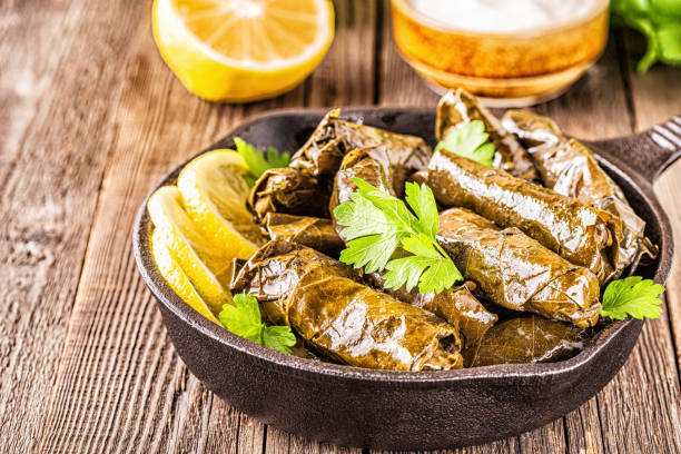 istock Dolma, stuffed grape leaves with rice and meat on dark background, selective focus 1163366519