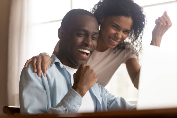istock African couple look at computer feels excited celebrating lottery win 1163367357