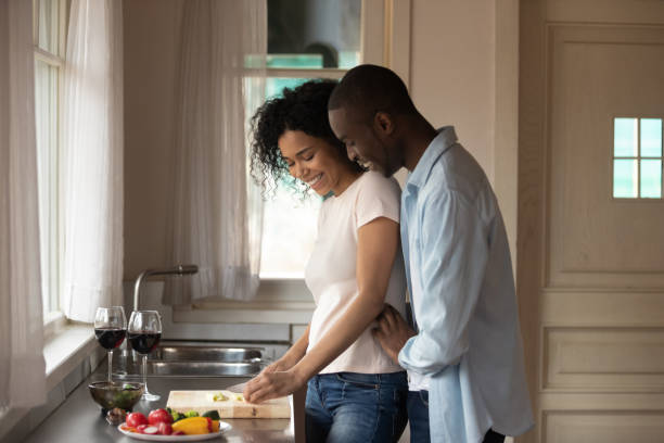 istock African romantic couple cooking together dinner in the kitchen 1163367365