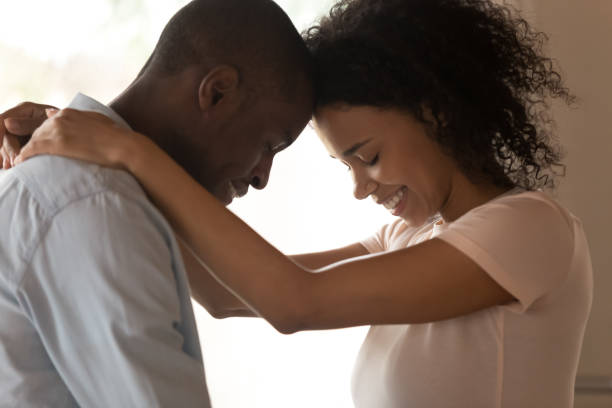 istock Side view profile faces of couple in love touching foreheads 1163367381