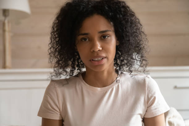 istock Closeup african talking woman looking at camera making video call 1163367398