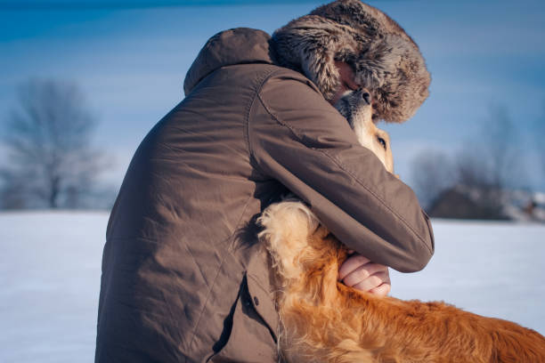 istock Man hiker and his dog on a mountain top 1163367419
