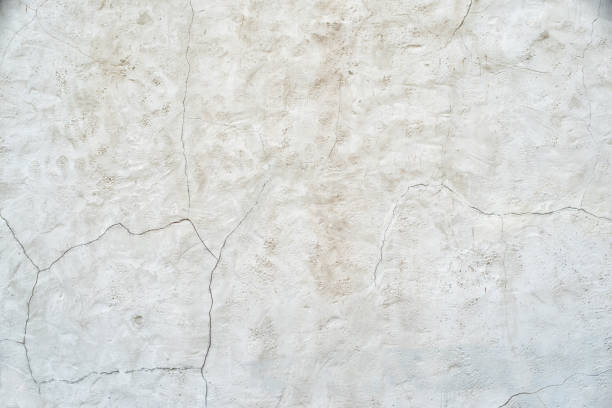 istock Old gray wall with cracks on the plaster. Abstract background 1163367807