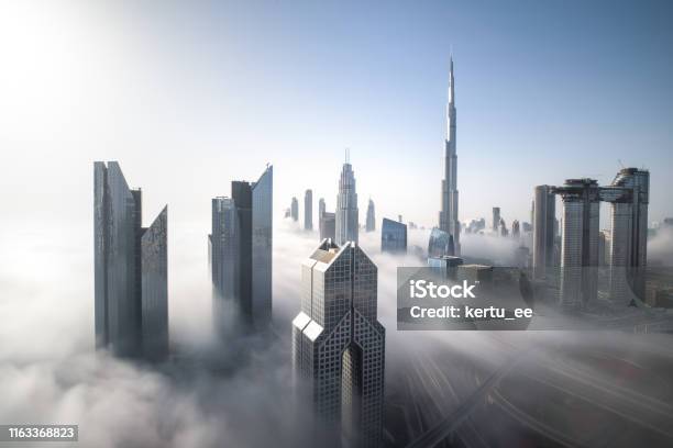 Dubai Downtown Skyline On A Foggy Winter Day Stock Photo - Download Image Now - Dubai, Urban Skyline, Cloud - Sky