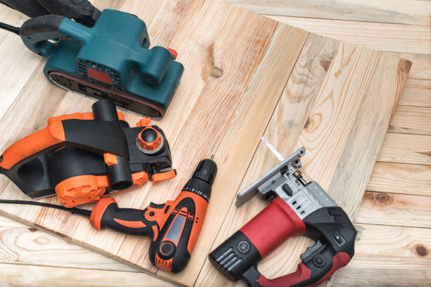 Set of handheld woodworking power tools for woodworking on light wooden background. Close up Set of handheld woodworking power tools for woodworking on light wooden background. Close up. construction equipment stock pictures, royalty-free photos & images