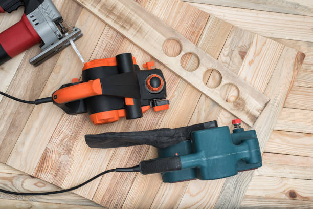 istock Set of handheld woodworking power tools for woodworking and the workpiece lies on a light wooden background. Directly above 1163368955