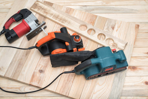 istock Set of handheld woodworking power tools for woodworking and the workpiece lies on a light wooden background. 1163368959