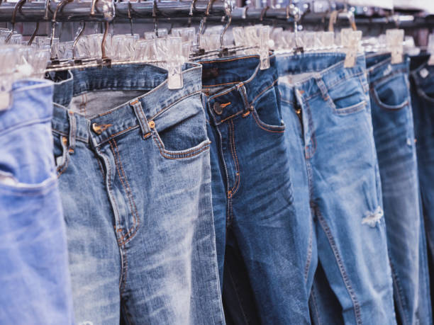 istock Close up row of many blue jeans are hanging 1163369108