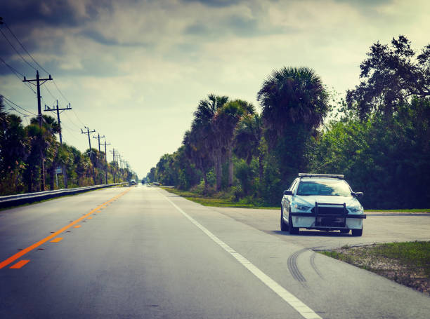 Sheriff car in Florida Everglades parked on the edge of the road on a cloudy day stock photo