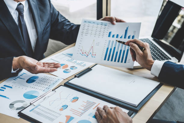 istock Two executive discussing company growth project success financial statistics, Partner meeting professional investor working start up project for both company with document, laptop and digital tablet 1163372080
