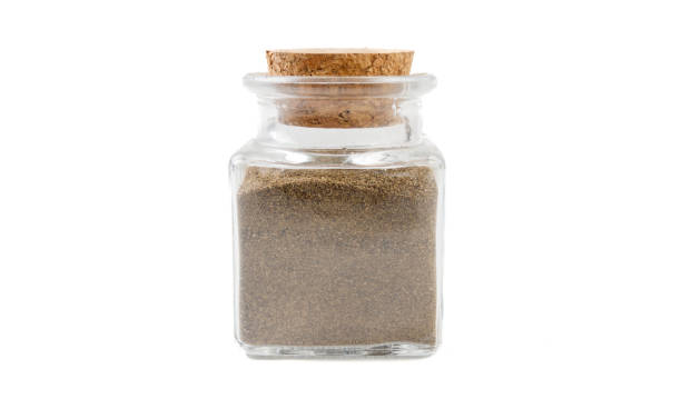 istock milled or ground black pepper in glass  jar on isolated on white background. front view. spices and food ingredients. 1163373821