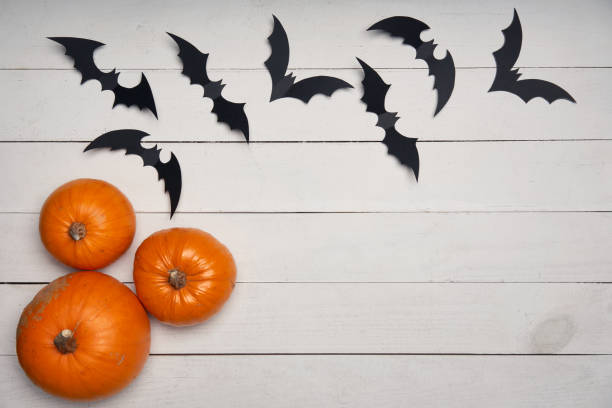 istock Halloween card with pumpkins and black bats 1163374821