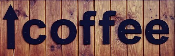 istock Lettering Coffe. Black letters on a wooden board. 1163374981