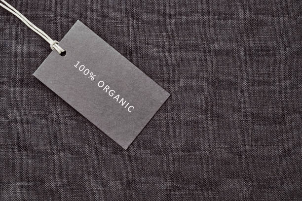 istock Label on linen fabric background. 100% organic materal 1163374994